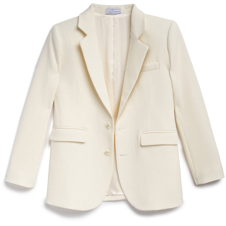 Wool Crepe w/ 5% Spandex. 100% Silk Lined. Jewel Button.. Elevate your wardrobe to a level of sophistication with our Billie Jacket Cream. Its luxurious fabric comprises of 5% spandex and 100% silk lining, providing a comfortable yet elegant fit. Adorned with jewel button accents, it's a timeless piece that exudes exclusivity and taste.